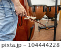 Real life young music students during rehearsals. Musical instruments and music stand with stave. 104444228