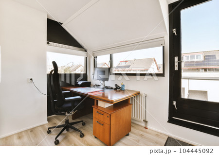 an office area with a desk, chair and large window looking out onto the cityscapearron com 104445092