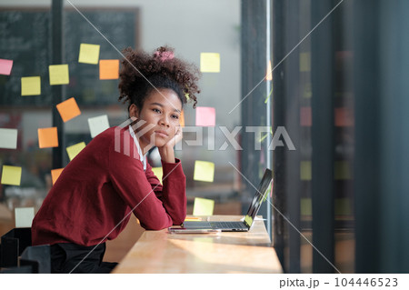 African American female employee write down on colorful sticky notes manage list, concentrated biracial woman work on startup brainstorm collaborate plan on stickers on glass wall African American female employee write down on colorful sticky notes manage list, concentrated biracial woman work on startup brainstorm collaborate plan on stickers on glass wall 104446523