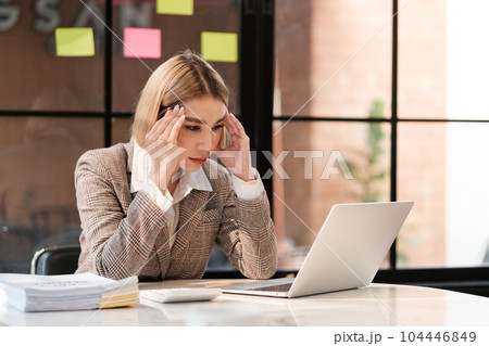 Asian woman working in the beautiful office with coffee computer and mobile phone. Asian woman working in the beautiful office with coffee computer and mobile phone. 104446849