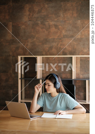 Smart asian Woman with computer online learning at home. Smart asian Woman with computer online learning at home. 104446875