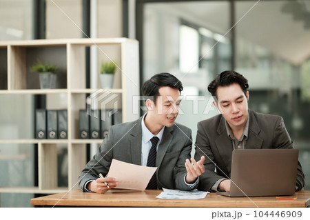 Group of business man discussion and brainstorming, bookkeeping audit graph and chart documents at desk, teamwork concept. Group of business man discussion and brainstorming, bookkeeping audit graph and chart documents at desk, teamwork concept. 104446909