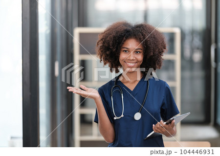 Portrait of female African American doctor with Stethoscope in her office at clinic. Portrait of female African American doctor with Stethoscope in her office at clinic. 104446931