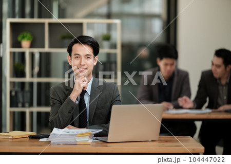 Handsome cheerful asian man executive business man at the workspace office  104447022