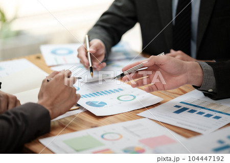 Close up group of business men and woman discussion and brainstorming, bookkeeping audit graph and chart documents at desk, teamwork concept. Close up group of business men and woman discussion and brainstorming, bookkeeping audit graph and chart documents at desk, teamwork concept. 104447192