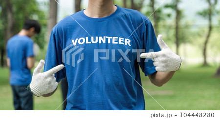 Close up young man volunteering wearing t-shirt with volunteer message Close up young man volunteering wearing t-shirt with volunteer message 104448280