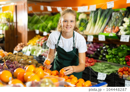 Girl at her first job in vegetable shop Girl at her first job in vegetable shop 104448287