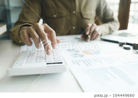 Accountant using calculator for calculate finance report in office Accountant using calculator for calculate finance report in office 104449660