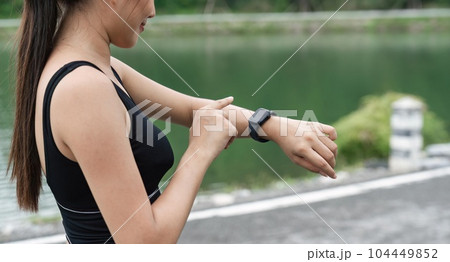 Asian women preparing to run with smart watches Check your heart rate for running in the park. Healthy active sport lifestyle concept 104449852