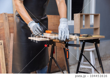 Woodworking is a hobby for senior male after retirement at home. Woodworking is a hobby for senior male after retirement at home. 104451616