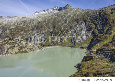 Alpine Lake at Oberalp Pass in Graubunden alps, Grisons, Switzerland 104452919