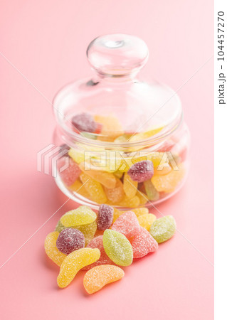 Mix of fruity jelly candy on pink background. 104457270