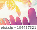 Surfboard and palm tree with blue sky on beach background. Travel adventure sport and summer vacation concept. Vintage tone filter effect color style. 104457321