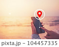 Woman hand using smart phone with navigator location point at tropical sunset beach abstract background. Technology interenet and travel adventure concept. Vintage tone filter effect color style. 104457335