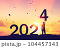 Man raise hand up on sunset sky with birds flying at top of mountain and number like 2024 abstract background. Happy new year and holiday concept. Vintage tone filter effect color style. 104457343