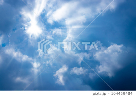 Sunbeam through the cloud on blue sky Sunbeam through the cloud on blue sky 104459484