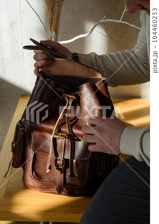 brown leather oldfashioned backpack. indoors photo 104460253