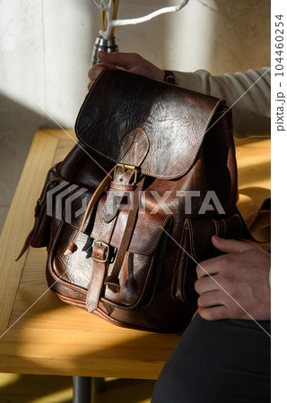 brown leather oldfashioned backpack. indoors photo 104460254
