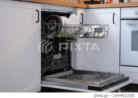 A lot of dirty dishes in the dishwasher. Helping the hostess, economy and ecology. Cleaning in the kitchen A lot of dirty dishes in the dishwasher. Helping the hostess, economy and ecology. Cleaning in the kitchen 104462288
