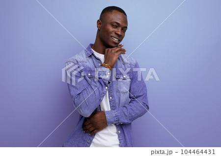 close-up portrait of a young handsome well-groomed african guy in a denim jacket on a studio close-up portrait of a young handsome well-groomed african guy in a denim jacket on a studio 104464431