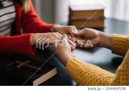 Asian men and women hands praying to god with the bible. Pray for god blessing. Religious beliefs Christian life crisis prayer to god. Asian men and women hands praying to god with the bible. Pray for god blessing. Religious beliefs Christian life crisis prayer to god. 104464536