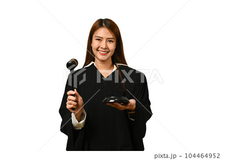 Portrait of female judge dressed in robe gown uniform with gavel hammer mallet isolated on white background Portrait of female judge dressed in robe gown uniform with gavel hammer mallet isolated on white background 104464952