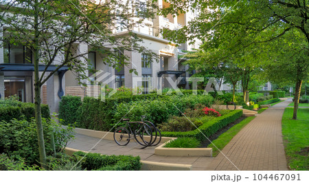 Shadowed passway along the residential building on summer evening time Shadowed passway along the residential building on summer evening time 104467091