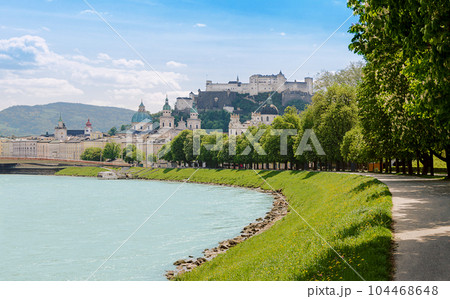 Salzburg, city in Austria, with Old Town and historic centre, seen from Salzach river and Franz-Josef-Kai, with Salzburg Cathedral, and Hohensalzburg Fortress. Festival city and birthplace of Mozart. 104468648