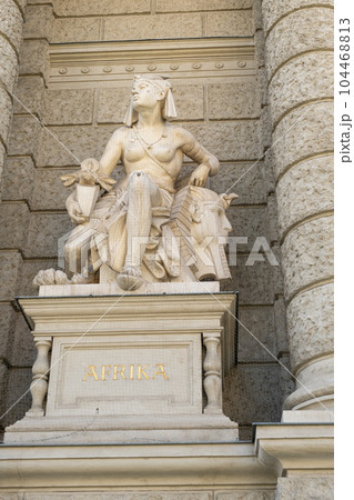 Sculpture woman and sphinx on a building in Austria in Vienna, text in German Afrika 104468813