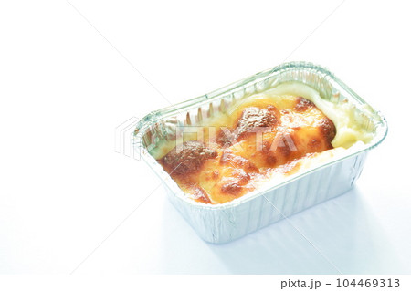 baked mashed potato with cheese in aluminum tray on white background baked mashed potato with cheese in aluminum tray on white background 104469313