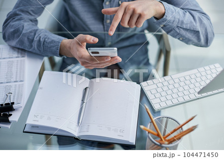 business man ceo wearing sitting in office using cell phone solutions. 104471450