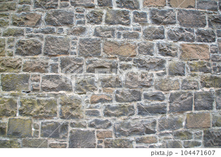 Old stone wall to be used as a background or texture. Ancient wall from old city. 104471607
