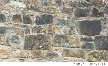 Old stone wall to be used as a background or texture. Ancient wall from old city. Old stone wall to be used as a background or texture. Ancient wall from old city. 104471611