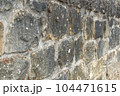 Old stone wall to be used as a background or texture. Ancient wall from old city. 104471615