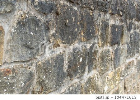 Old stone wall to be used as a background or texture. Ancient wall from old city. Old stone wall to be used as a background or texture. Ancient wall from old city. 104471615