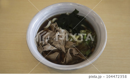 A bowl of Niku udon, soup noodles with sliced beef 104472358