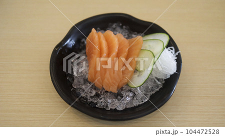 Sliced raw salmon fish or salmon fillet or salmon sashimi as Japanese food restaurant. Asian food Japan sushi restaurant menu. Sliced raw salmon fish or salmon fillet or salmon sashimi as Japanese food restaurant. Asian food Japan sushi restaurant menu. 104472528