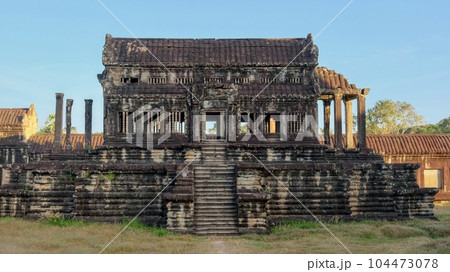 An antiquated Khmer structure lies abandoned amidst the ruins of the medieval city of Angkor, its silent presence evoking an air of mystique. An antiquated Khmer structure lies abandoned amidst the ruins of the medieval city of Angkor, its silent presence evoking an air of mystique. 104473078