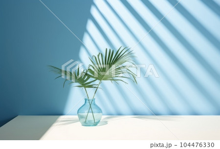 Light blue wall with shade and plant on the floor in a vase Light blue wall with shade and plant on the floor in a vase 104476330