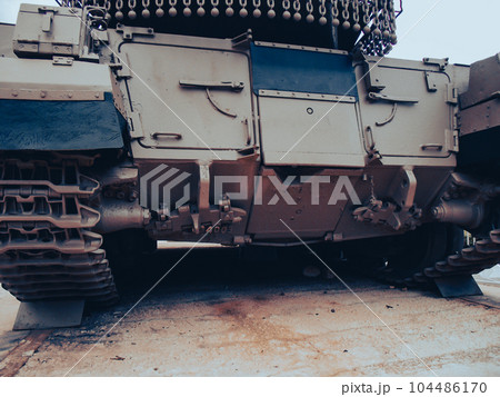 Ultra close-up of the caterpillar track of stationary war tank in an undisclosed location Ultra close-up of the caterpillar track of stationary war tank in an undisclosed location 104486170