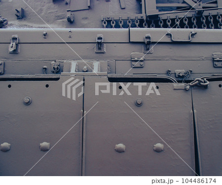 Ultra close-up of the caterpillar track of stationary war tank in an undisclosed location 104486174