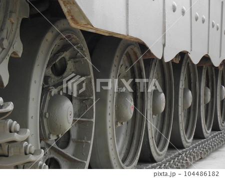 Ultra close-up of the caterpillar track of stationary war tank in an undisclosed location 104486182