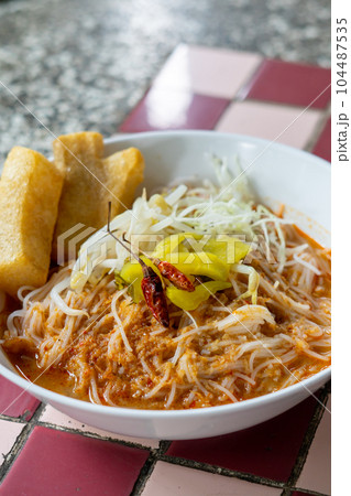 Rice noodles in fish curry sauce with vegetables Rice noodles in fish curry sauce with vegetables 104487535