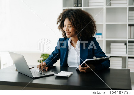 African Woman freelancer is working her job on computer tablet and laptop Doing accounting analysis report real estate investment data, Financial at office African Woman freelancer is working her job on computer tablet and laptop Doing accounting analysis report real estate investment data, Financial at office 104487759