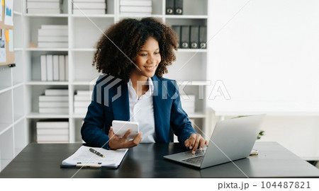 African Woman freelancer is working her job on computer tablet and laptop Doing accounting analysis report real estate investment data, Financial at office African Woman freelancer is working her job on computer tablet and laptop Doing accounting analysis report real estate investment data, Financial at office 104487821