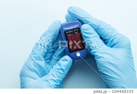 Pulse oximeter in doctor hand Pulse oximeter in doctor hand 104488335