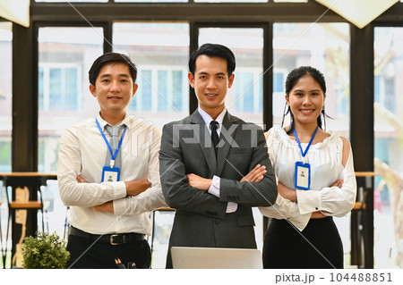 Confident businesspeople standing with their arms crossed and looking at camera 104488851