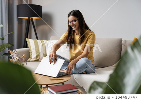 Getting to work. Enthusiastic young woman student opening the lid of laptop ready to start new classes 104493747