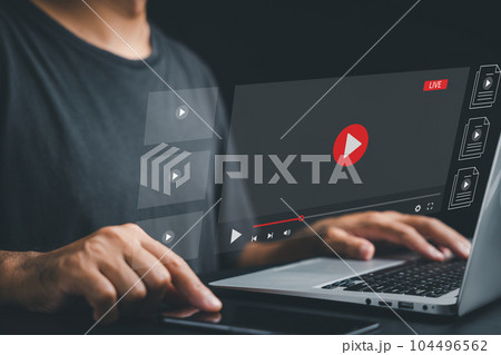 Businessman captivated by a live stream on his laptop. Online video streaming concept with a multimedia player. Experience the excitement of virtual events and real-time content. 104496562