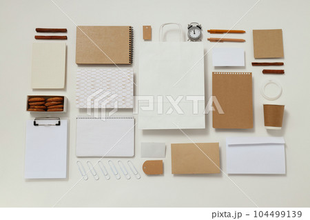 Mockup flat lay with different office accessories on white background Mockup flat lay with different office accessories on white background 104499139